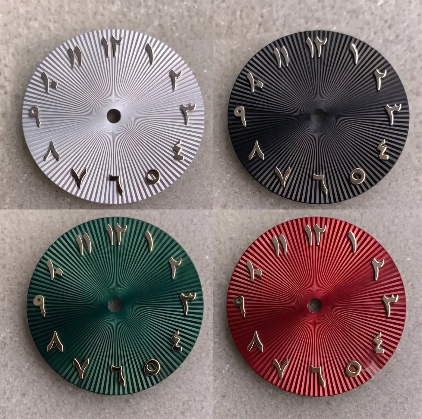 The four Union Collection dials: silver-white, black, green and red, each with applied gold Arabic numerals